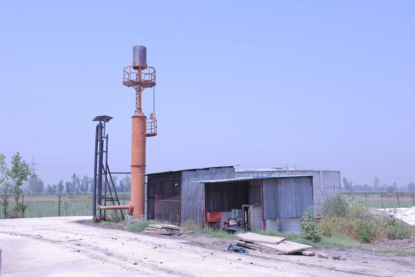 Biogas flare stack beside the gas-handling shed at the Meerut plant